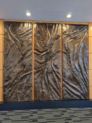 This triptych on the back of an elevator wall is mesmerizing