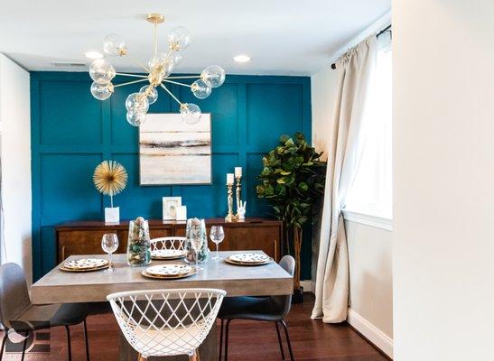 Modern dining room with a custom wall and punch of color.