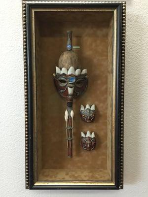 This is a 5" deep shadow box frame of an authentic Blow Dart Gun.