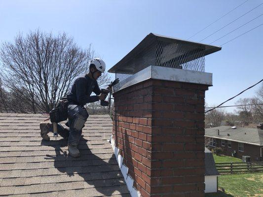 One of our lead production guys Zeke installing a chimney cap.