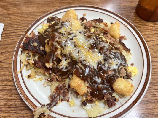 The poutine plate - hash browns, scrambled eggs, bacon crumbles, cheese curds, cheddar, and gravy.