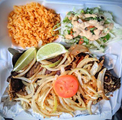 Whole fried fish with rice and salad