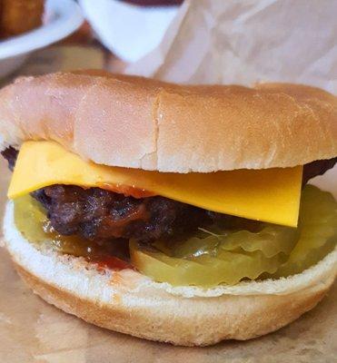 Hand-packed cheeseburger with pickles, onion, mustard, and ketchup, $5.75.