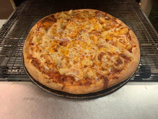 Paia Pie Signature Pizza with Canadian bacon, pineapple, and Mandarin oranges.