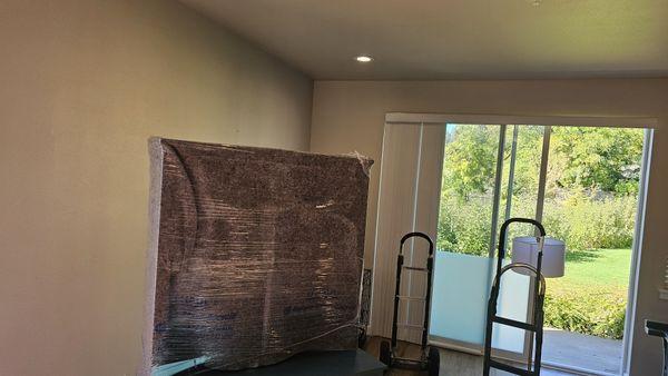 Shrinkwrap and pad on furniture and 2 professional hand trucks