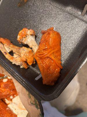 Bone in classic hot wing WITH FEATHERS IN IT!?!?