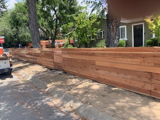 Horizontal red wood fence style.