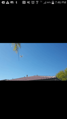 Bruce using a drone and camera to inspect the tile roof on our new home.