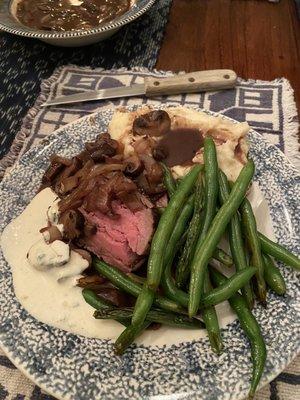 Beef tenderloin, garlic roasted mashed potatoes, green beans, mushrooms in red wine sauce, and horseradish sauce.