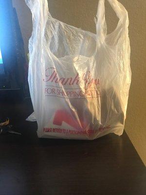 A shopping bag with the food in a brown bag and very cold infull cup of fries very dissatisfied