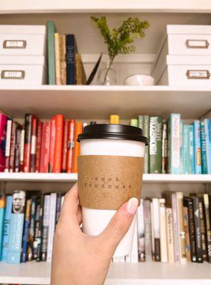 Jericho's cute coffee cup sleeves, in front of my color-coded bookcase LOL