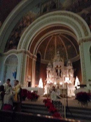 Receiving Holy Communion while kneeling pre 1962 style.  Only the host, no cup of wine offered.