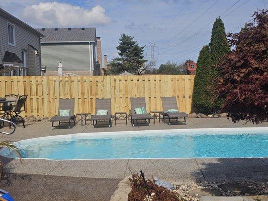 A Shadowbox Pressure Treated Pine Fence installed with Postmaster Steel Posts