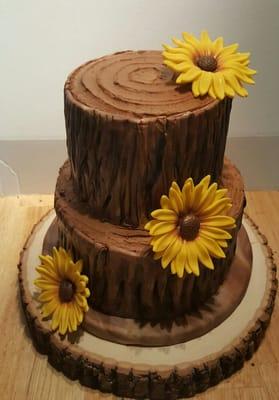 Custom fondant Tree stump wedding cake with handmade hand made fondant sunflowers.