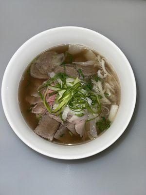 Combination pho is a Vietnamese soup dish that is made with a flavorful broth, rice noodles and a variety of thinly sliced meats.