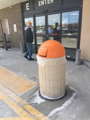 Garbage can and shaped like a silo.