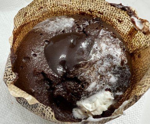 Chocolate lava cake after being warmed up with some whip cream