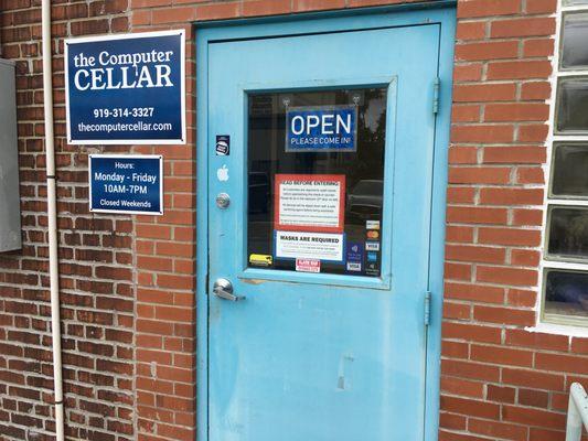 The main door. There are signs about requiring masks and immediate handwashing upon entering.