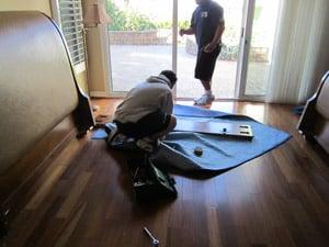 movers protecting a headboard all items are properly protected from damage during your move