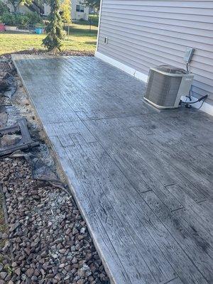 Wood planking stamped concrete patio