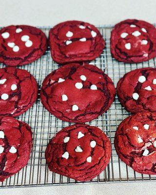 Red velvet cookie stuff with cream cheese frosting topped with white chocolate chips