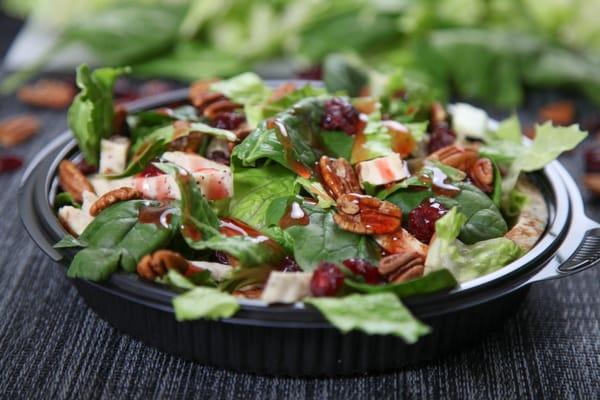 Our Romaine and Spinach salad has Chicken, Pecans and dried cranberries. Get it with Raspberry Vinaigrette