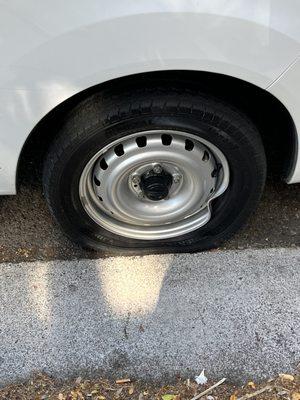 Before: curbed rim and flat tire