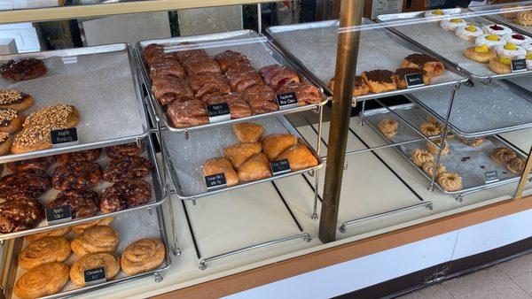 Mid-morning selection of doughnuts. Classic styles and flavors: fritters, bear claws, crullers, jelly-filled, and more.