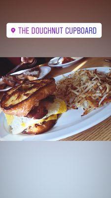 Brunch Burger with hamburger, bacon, egg on a donut with a side of hash browns