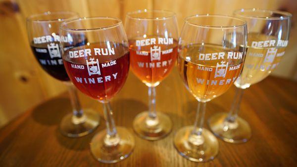 Rainbow assortment of Deer Run wines photographed in wine glasses