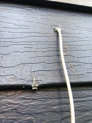 Installation tech not only put a hole in house for wire, also let drill bit ruin siding.