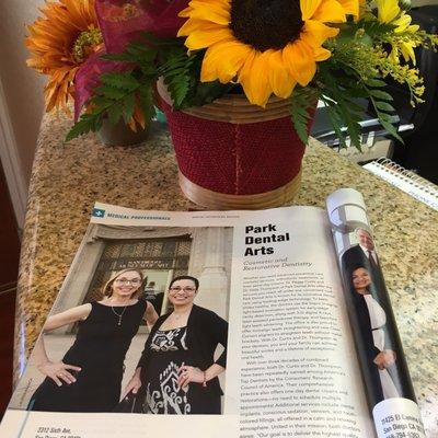 San Diego magazine article on Park Dental Arts dentists, Dr. Peggy Curtis and Dr. Hilda Thompson next to beautiful bouquet of Fall flowers.