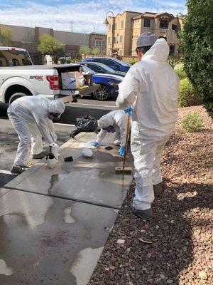 A team of biohazard techs performing a blood spill cleanup. Concrete is porous and will absorb fluids, so a speedy cleanup is necessary.