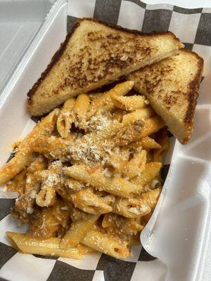 Penne Bolognese served with Texas toast on the side to soak up all the leftover sauce