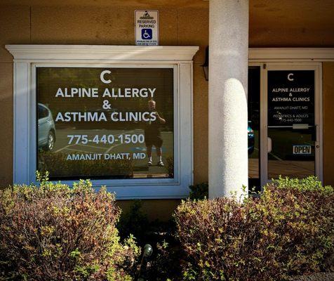 Outer walls with signage in the window for the clinic and on the front door.