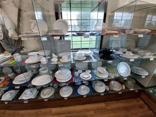 Various dinnerware, plates, bowls, cups, on display and available for sale