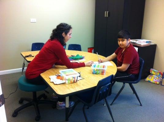 Our OT working on fine motor activities with a child.