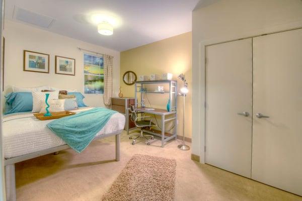 Fully furnished bedrooms with full size closet and bed, stackable dressers and a desk.