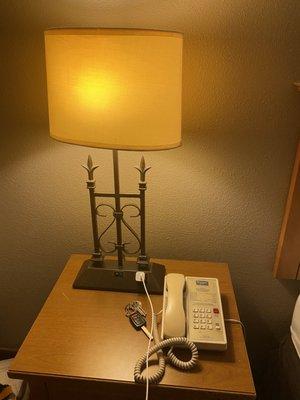 Phone and lamp at the night stand