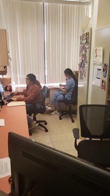 Damiana and Linda reviewing my files and scheduling next appointment.