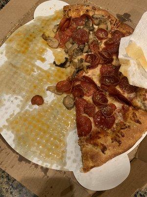 The entire pizza was soaked in grease. This is what underneath the pizza looked like. Couldn't eat it. Disappointed. Price was almost $20