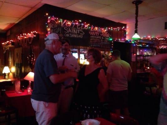 Peeps aside of the bar watching the band and socializing