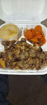 Hibachi steak w/ mushrooms on a bed of rice and a side of carrots.