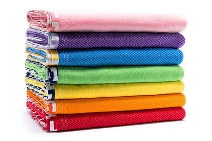 Blankets in an assortment of colors and materials.