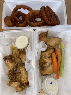 Delivery by Uber eats. Lemon pepper and Garlic Parmesan wings with onion rings.