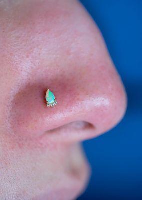 Fresh Nostril Piercing adorned with 'LEIA' in 14k Gold, Opal and Diamonds by Modern Mood Body Jewelry.