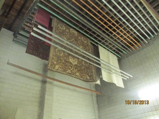 Rugs hanging in our heated drying room.