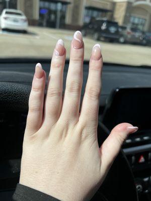 Hand in car with pink French tip nails