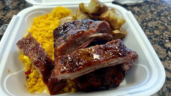 Baby back, ribs, yellow rice, and roasted potatoes.