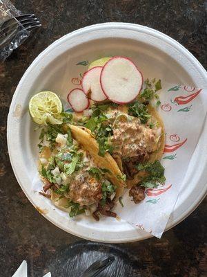 Birria Tacos with queso fundido on top